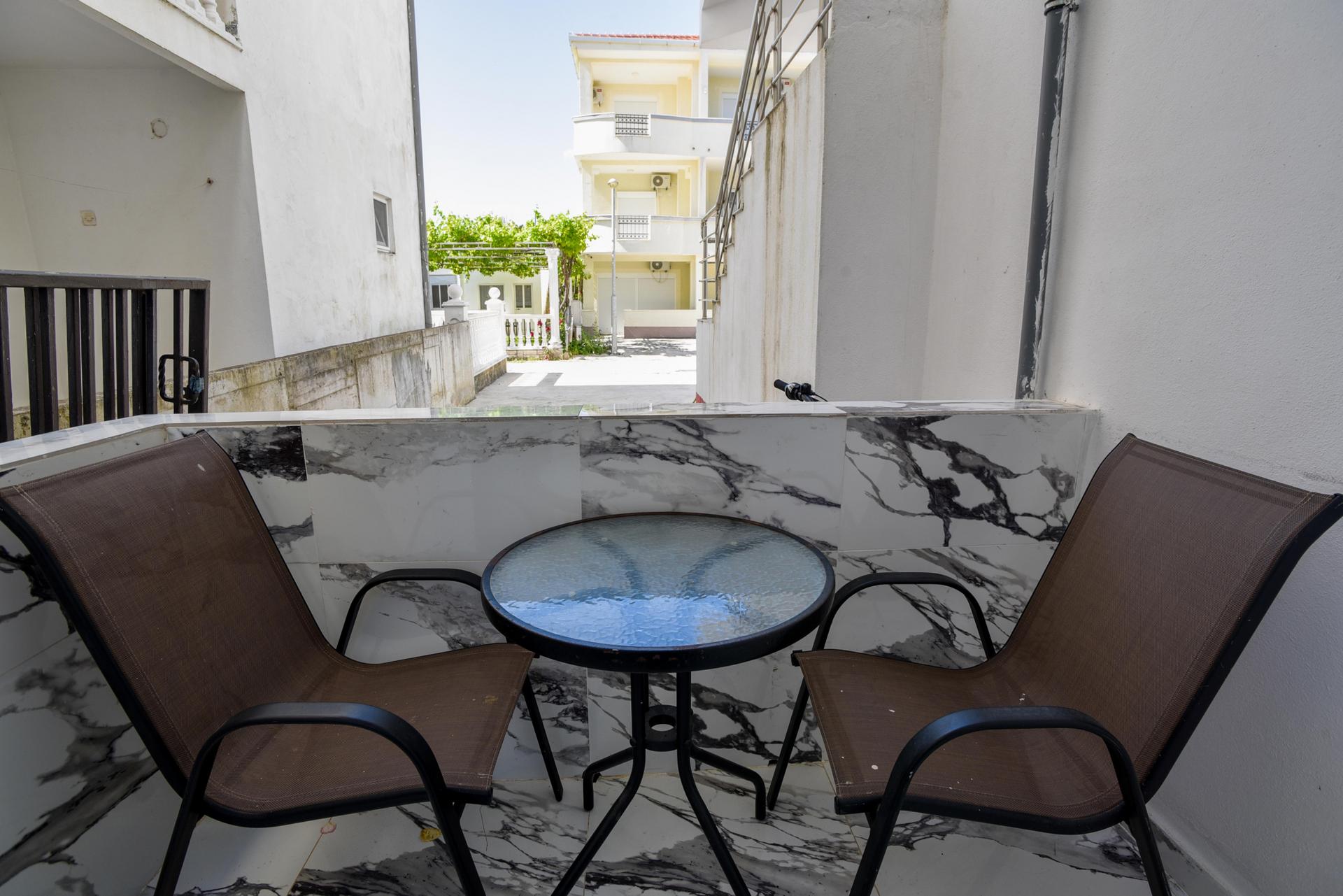 Enjoy morning coffee or evening drinks on our house's private balcony, a delightful space for relaxation.