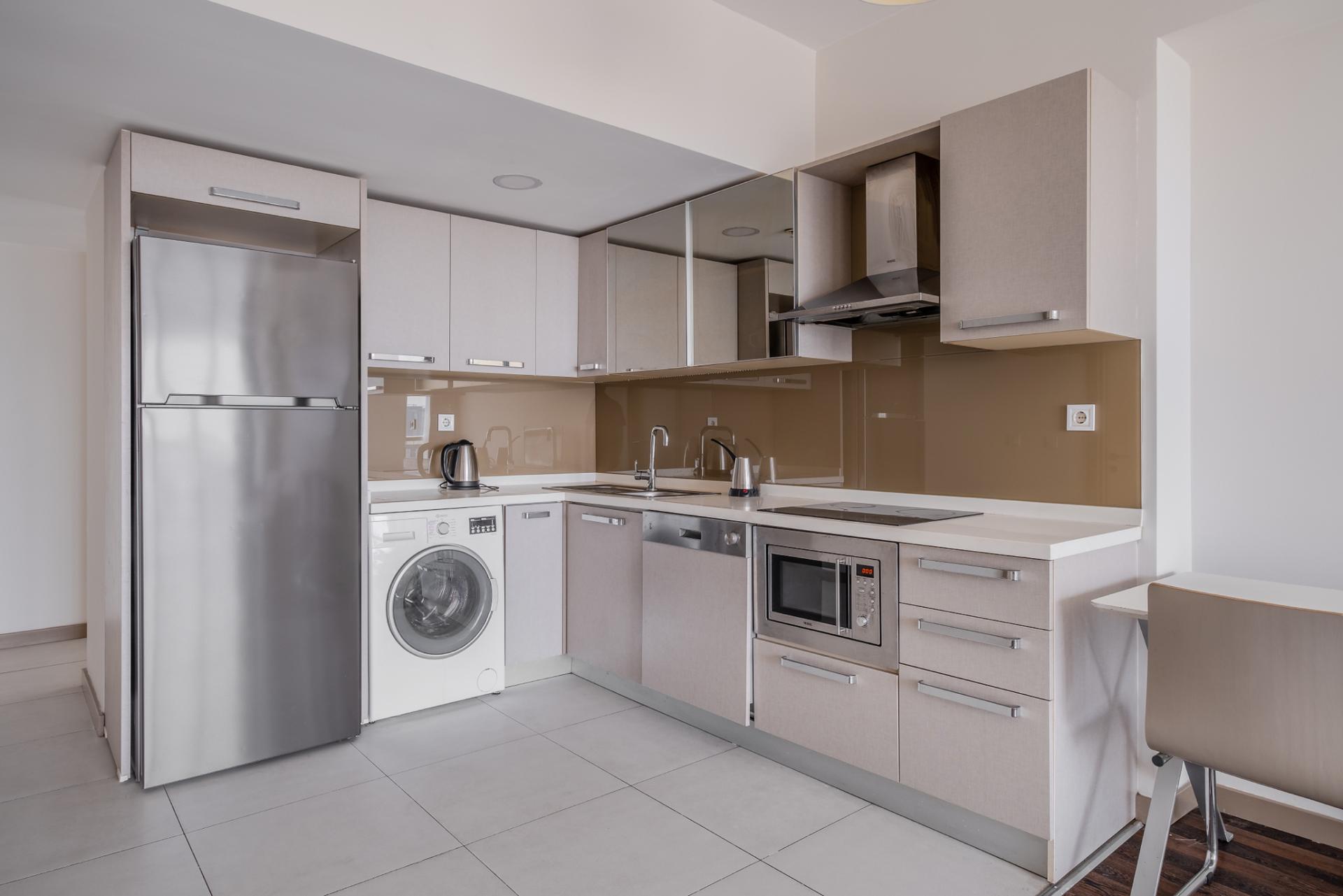 A well-lit, American-style kitchen featuring modern appliances and spacious countertops.