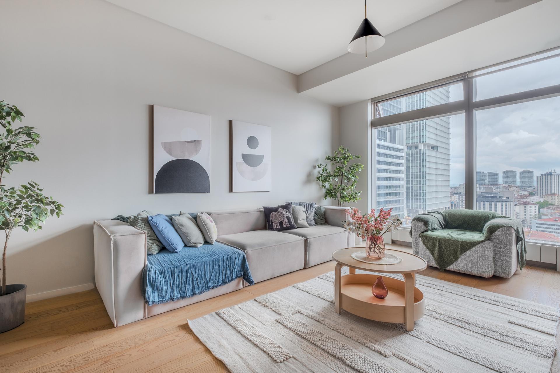 A spacious living room filled with natural light and minimalist decor.