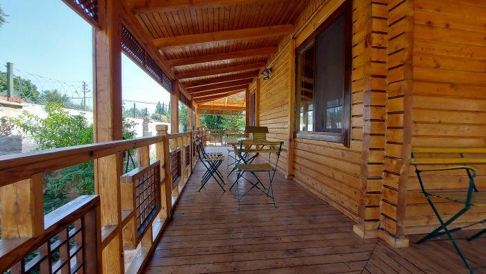 A perfect spot for a quiet moment, this cozy balcony offers charming views of the surrounding nature.