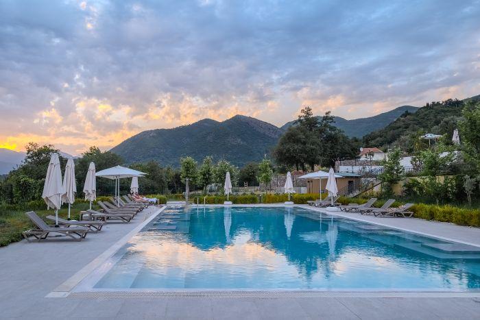 Enjoy a refreshing swim in our pristine pool, surrounded by lush greenery and vibrant flowers.