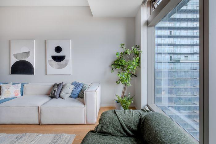 A chic living room bathed in soft pastel tones, exuding a serene ambiance.